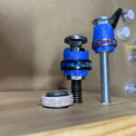 Blue ringed bolts and washers on wood