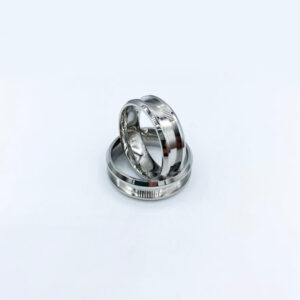 Two polished silver wedding rings on white background