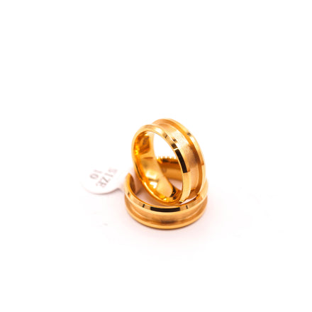 Two gold wedding bands on white background