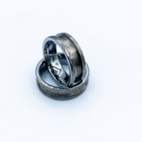 Two brushed metal wedding bands on white