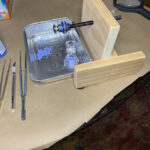 DIY wooden clamp with purple beads and tweezers