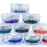 Stacked clear jars of colorful craft stones