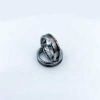 Interlocking silver wedding rings on white background