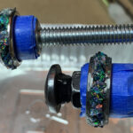 Two opal inlay rings clamped for polishing