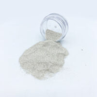 Small jar spilling fine white sand