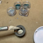 Craft workspace with glitter jars and scoop