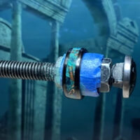 Threaded bolt with blue tape and patina ring