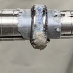 Close-up opal inlay ring on metal mandrel
