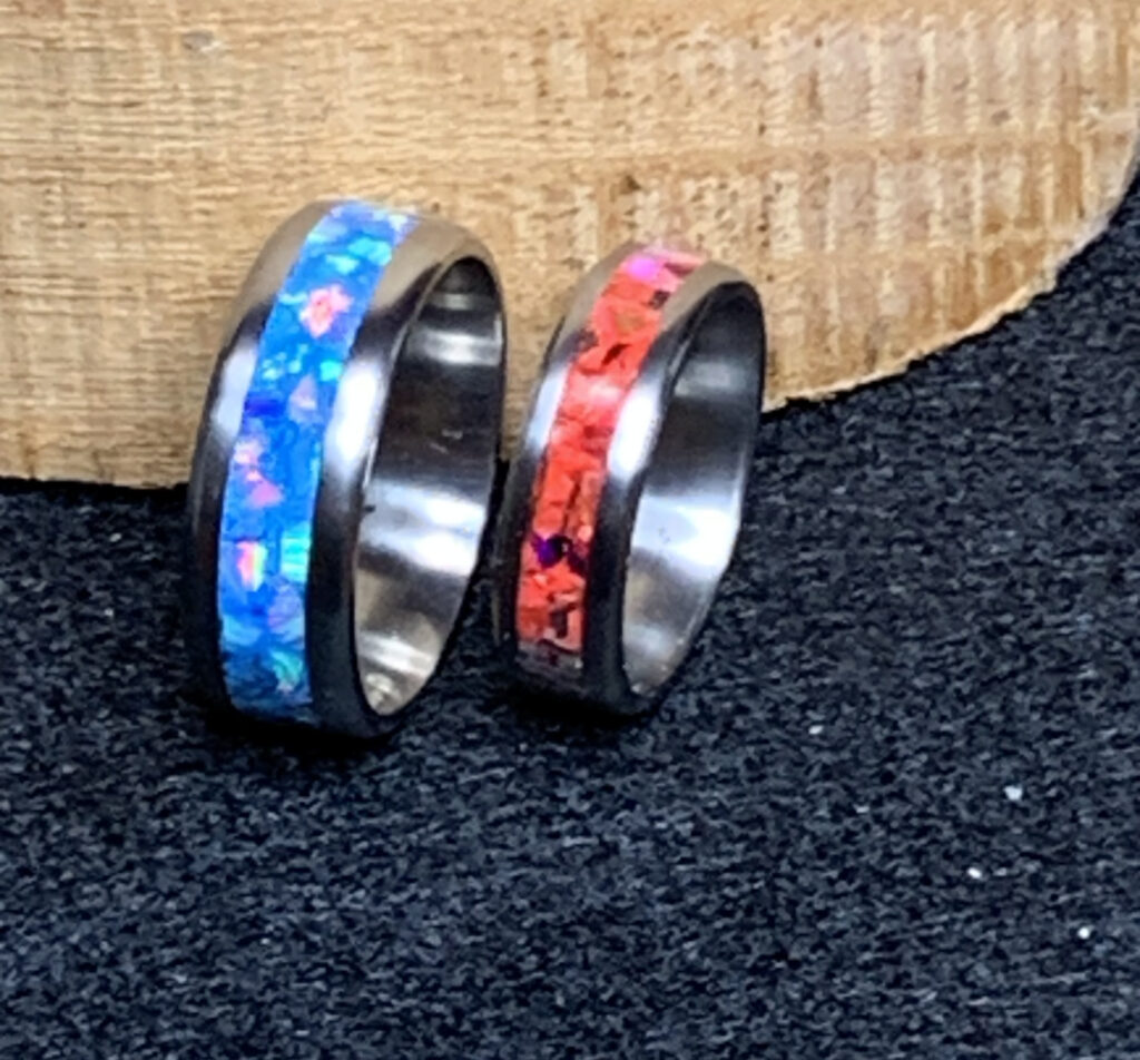 Two rings with iridescent blue and red inlays