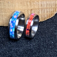 Two rings with iridescent blue and red inlays