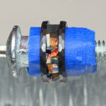 Screw with blue spacer and opal inlay ring