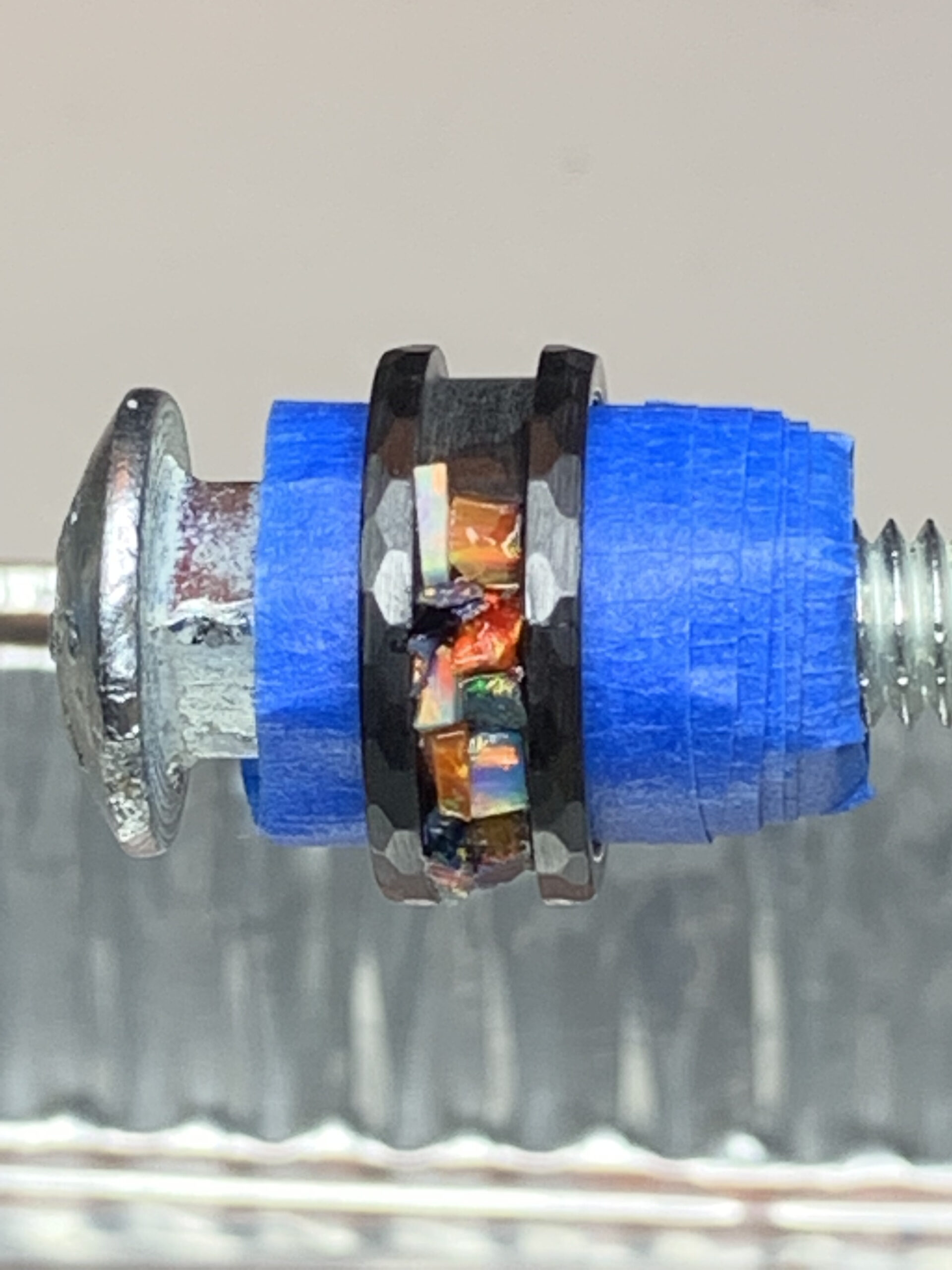 Screw with blue spacer and opal inlay ring