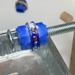Blue 3D-printed coupling on threaded rod