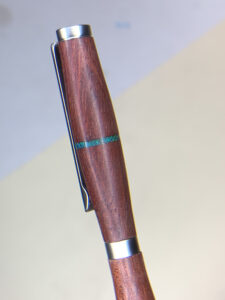 Wooden pen barrel with silver clip